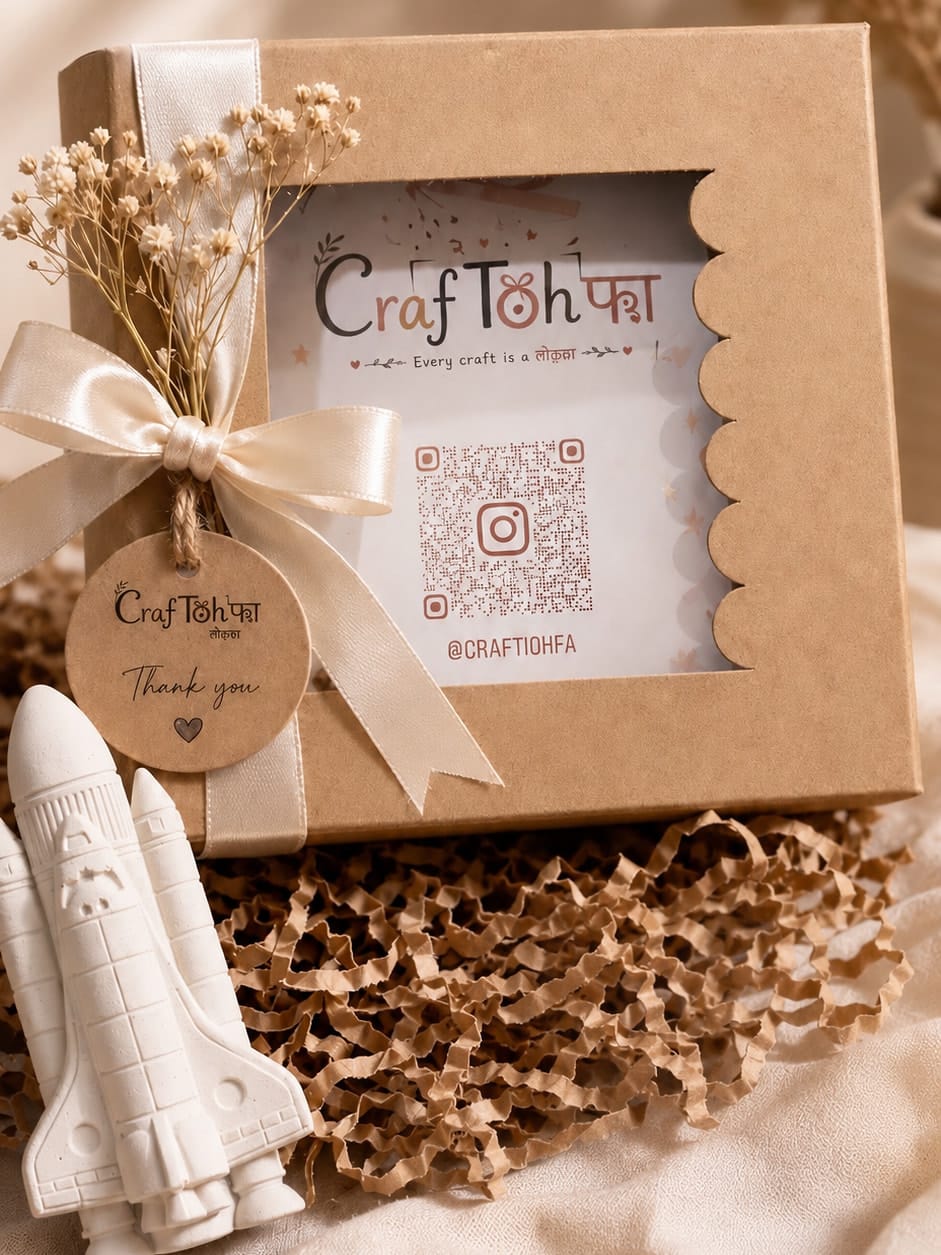 A ribboned Craftohfa gift box with dried flowers, a thank-you tag and a paint-your-own space rocket
