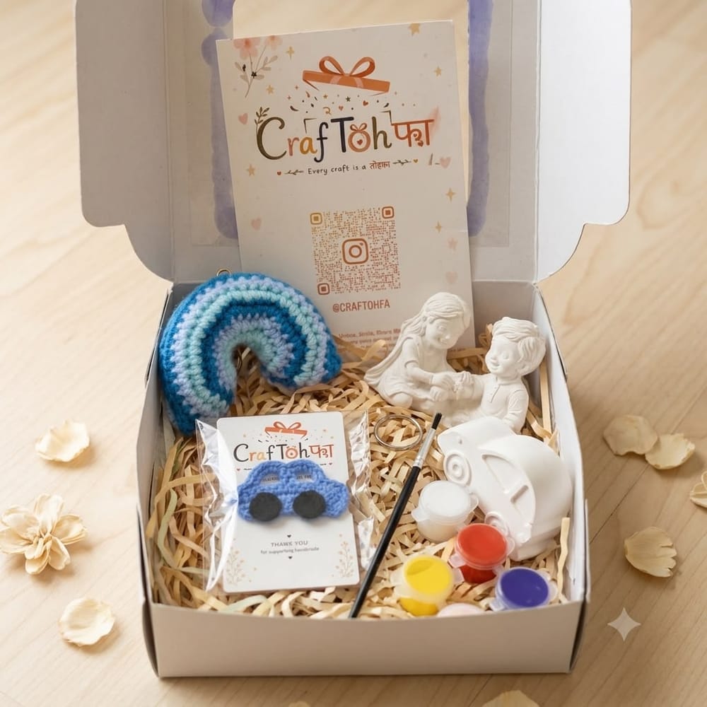 An open combo box with a teal and lilac crochet rainbow, a blue crochet car charm, an idol and a plaster car money box with four paint pots and a brush