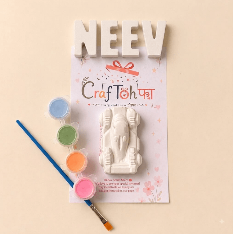 Unpainted plaster letters spelling "NEEV" above a plaster racing car, with blue, green, orange and pink paint pots and a brush on a printed Craftohfa card